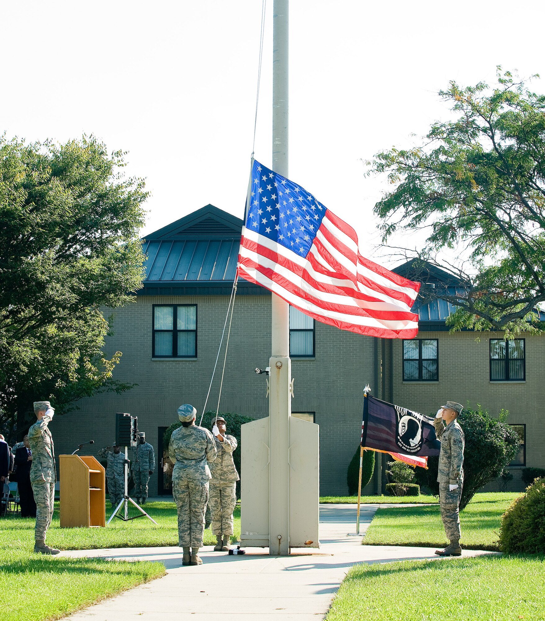 A four-person Base Honor Guard flag detail ceremoniously lowers the U.S. flag during the National POW/MIA Recognition Day retreat ceremony Sept. 18, 2015, on Dover Air Force Base, Del. Lt. Col. Michael McCoy, 436th Operations Group deputy commander, was the commander of troops for the ceremony in which the men and women of Dover AFB paid tribute to all prisoners of war, missing in action and their families. (U.S. Air Force photo/Roland Balik)