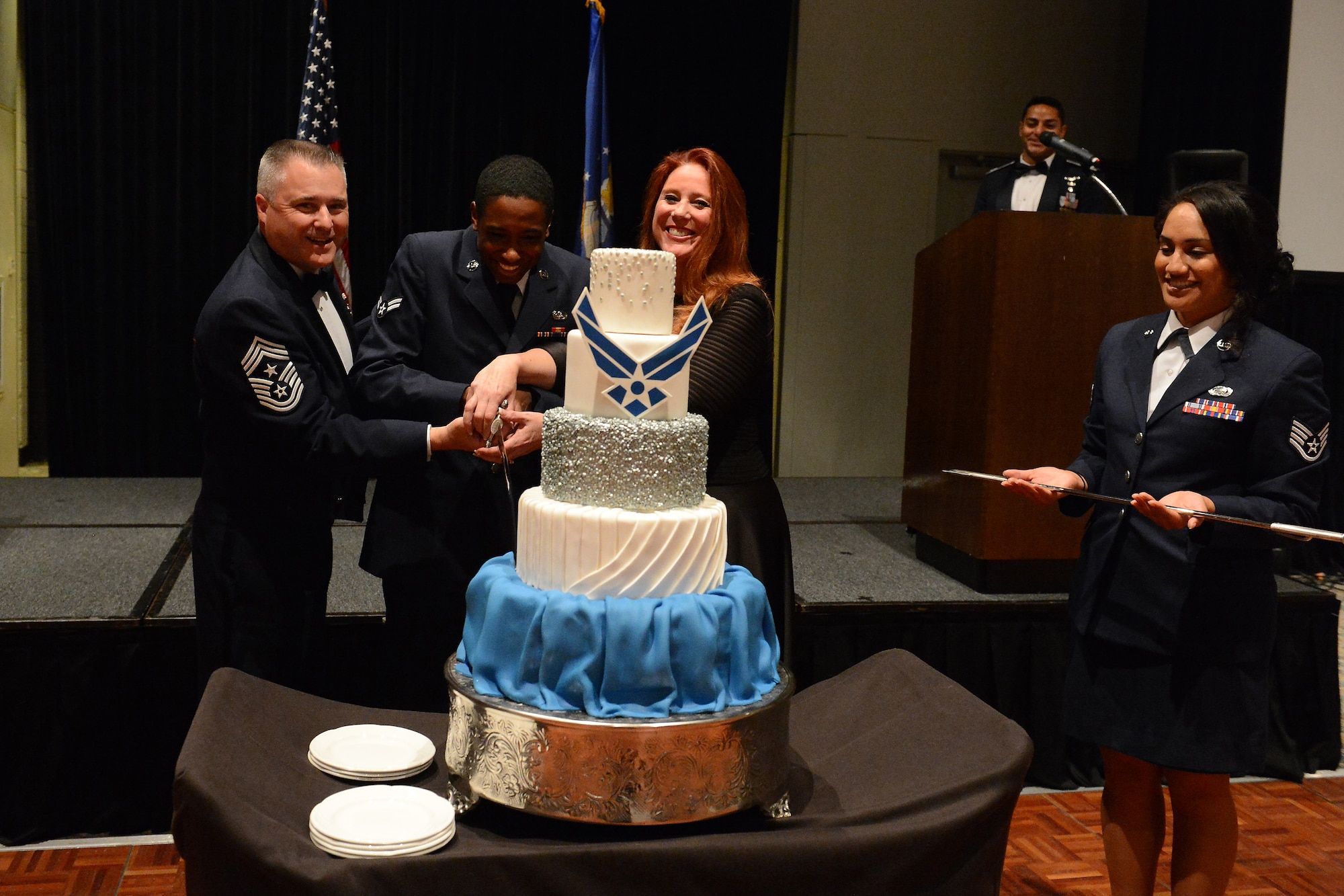 From left to right, Chief Master Sgt. Anthony Mack, 446th Airlift Wing command chief, Airman 1st Class Iroquois Smallwood, 627th Communications Squadron cyber systems operations specialist and Kim Wyman, Washington secretary of state, cut the cake during the McChord Field Air Force Ball Sept. 18, 2015, at Tacoma, Wash. The tradition is the oldest and youngest Airmen at the Ball cut the cake. (U.S. Air Force photo/ Staff Sgt. Tim Chacon)