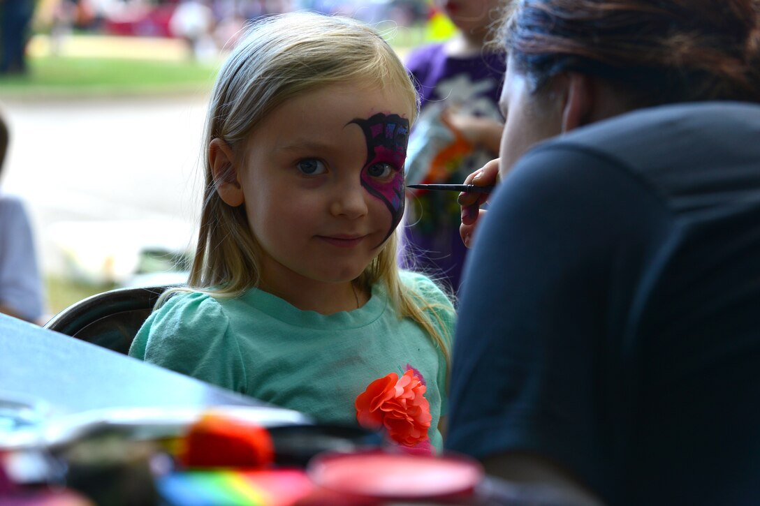 Olivia Galbraith, daughter of U.S. Army Col. William S. Galbraith, 733rd Mission Support Group commander, has her face painted during the Fall Festival at Fort Eustis, Va., Sept. 19, 2015.  The event included both fun and educational booths and displays ranging from arts and crafts to martial arts training.  (U.S. Air Force photo by Staff Sgt. Natasha Stannard/Released)