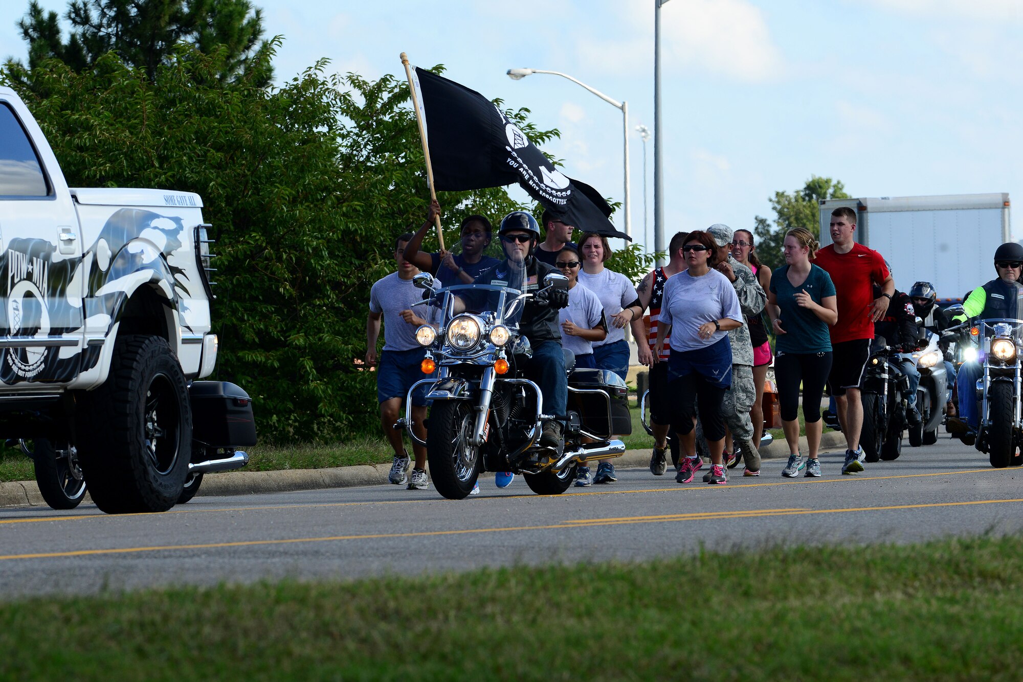 Participants run the final leg of the Joint Base Langley-Eustis, Va., 24-hour Prisoner of War/Missing in Action vigil at Langley Air Force Base, Va., Sept. 18, 2015. This year marked the 6th annual JBLE POW/MIA Recognition Day run/walk to remember U.S. Service members captured in time of war, who paid the ultimate sacrifice and those still unaccounted for. (U.S. Air Force photo by Senior Airman Kimberly Nagle/Released)