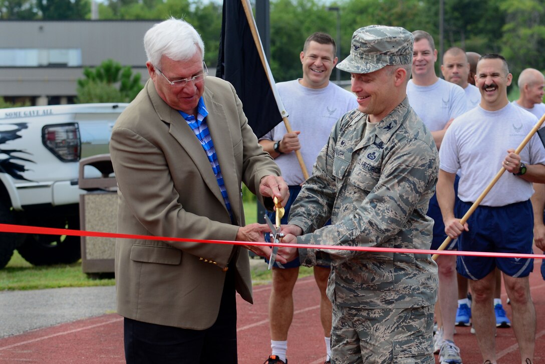 Retired U.S. Air Force Lt. Gen. Glen “Wally” Moorhead, III and Col. Timothy D. Haugh, 480th Intelligence, Surveillance and Reconnaissance Wing commander, cut a ribbon at the start of a 24-hour Prisoner of War/Missing in Action commemoration run/walk at Langley Air Force Base, Va., Sept. 17, 2015. Members of Joint Base Langley-Eustis, Va., either ran or walked with the POW/MIA flag in honor of imprisoned and unaccounted for U.S. Service members. (U.S. Air Force photo by Senior Airman Kimberly Nagle/Released)