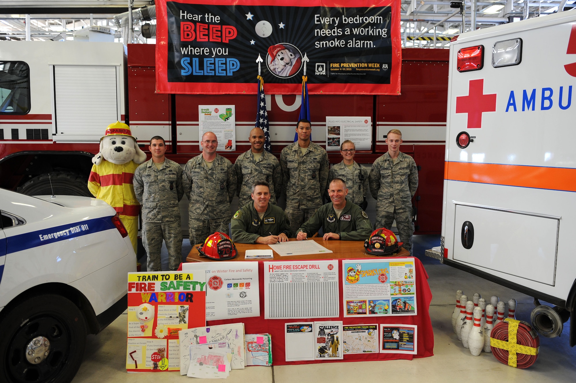 Col. Jason Armagost, 5th Bomb Wing commander and Col. Michael Lutton, 91st Missile Wing commander, sign a proclamation at Minot Air Force Base, N.D., Sept. 21, 2015. The proclamation represents the cooperation of all members of Minot AFB, both the 5th BW and 91st MW, to work toward continuing great fire prevention for the community. (U.S. Air Force photo/Senior Airman Kristoffer Kaubisch)