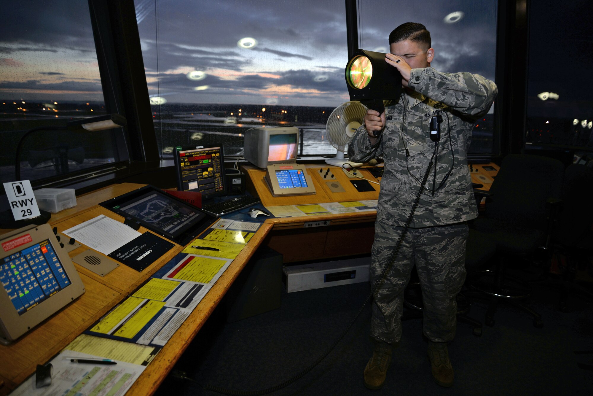 U.S. Air Force Senior Airman Drew Kalina, 100th Operations Support Squadron air traffic controller, demonstrates how to use a light gun in the air traffic control tower Sept. 21, 2015, on RAF Mildenhall, England. A light gun is used when there is no way of communicating with pilots via radio. (U.S. Air Force photo by Senior Airman Christine Halan/Released)