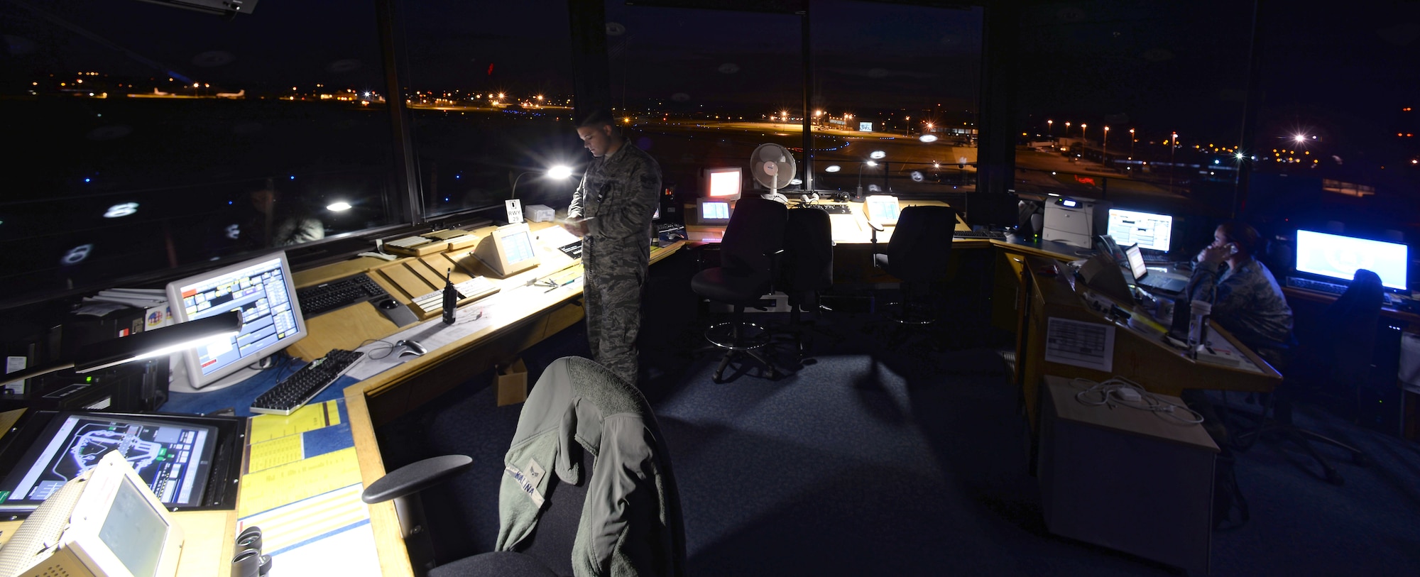 Air Traffic Controllers with the 100th Operations Support Squadron work diligently directing pilots of incoming and outgoing aircraft from the control tower Sept. 22, 2015, on RAF Mildenhall, England. The ATC team mans the tower 24/7. (U.S. Air Force photo by Senior Airman Christine Halan/Released) 