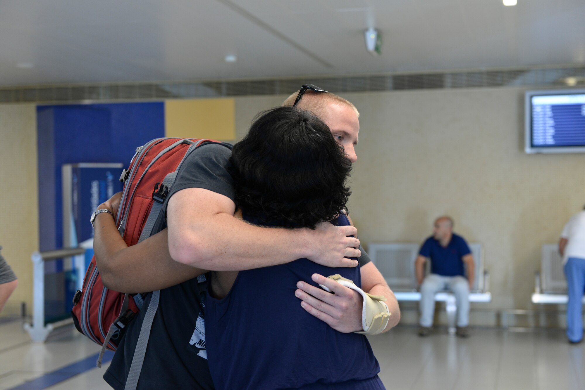 Airman 1st Class Spencer Stone, 65th Medical Operations Squadron ambulance service technician embraces Chief Master Sgt. Maxine White, 65th Medical Group superintendent at the Lajes Field. Azores  Sept 22, 2015. Stone, along with childhood friends Aleksander Skarlatos and Anthony Sadler, was recently honored by U.S. President Barack Obama at the White House for subduing an armed gunman when he entered their train carrying an assault rifle, a handgun and a box cutter.  Stone is returning to his home unit for the first time in nearly a month after receiving medical care and traveling throughout the U.S. after the Paris train attack incident.   (U.S Air Force photo/1st Lt. Alexandra Trobe). 
