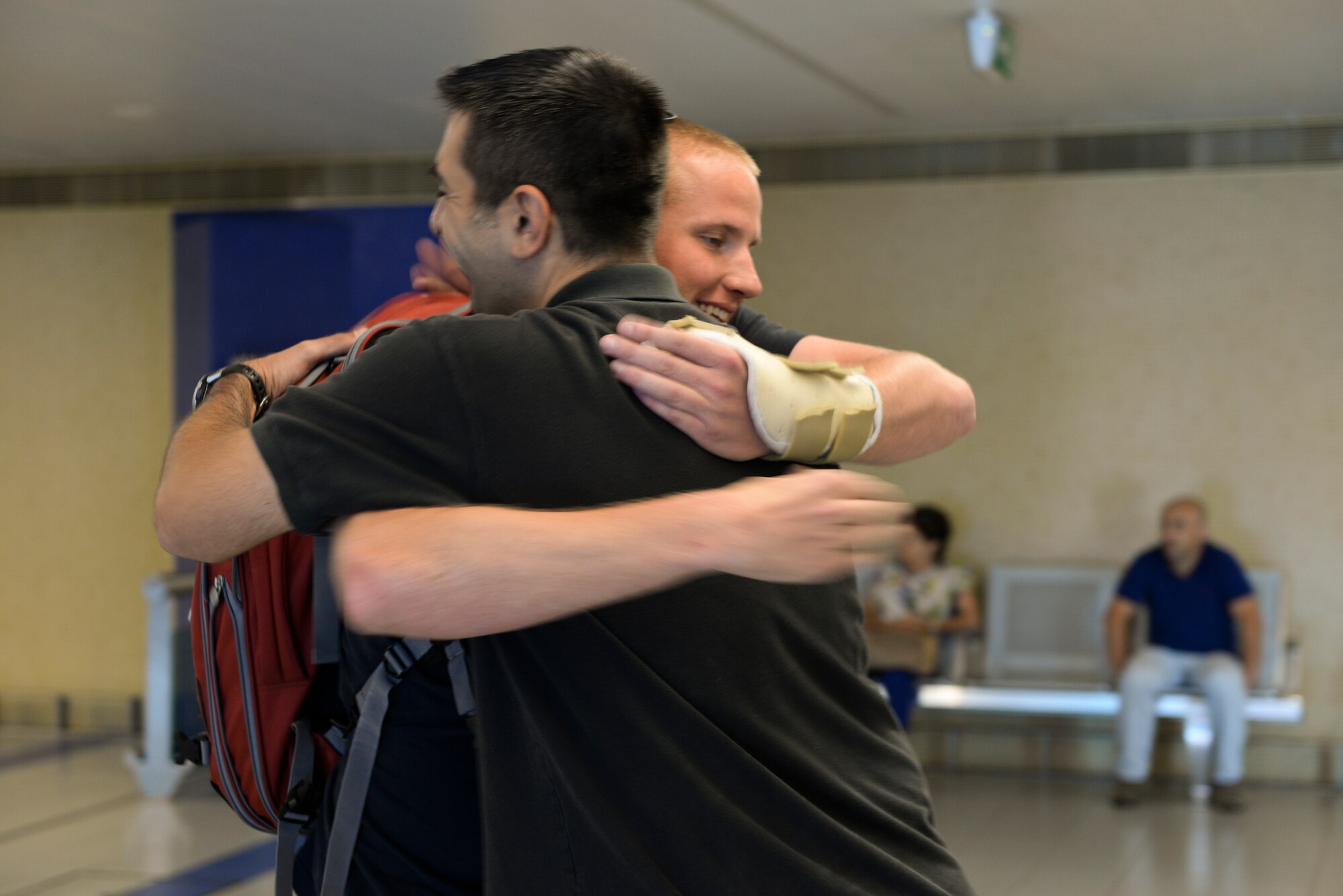 Airman 1st Class Spencer Stone, 65th Medical Operations Squadron ambulance service technician embraces Master Sgt. Andrew Springstead, 65th Medical Operation Squadron superintendent at the Lajes Field. Azores  Sept 22, 2015. Stone, along with childhood friends Aleksander Skarlatos and Anthony Sadler, was recently honored by U.S. President Barack Obama at the White House for subduing an armed gunman when he entered their train carrying an assault rifle, a handgun and a box cutter.  Stone is returning to his home unit for the first time in nearly a month after receiving medical care and traveling throughout the U.S. after the Paris train attack incident.   (U.S Air Force photo/1st Lt. Alexandra Trobe). 