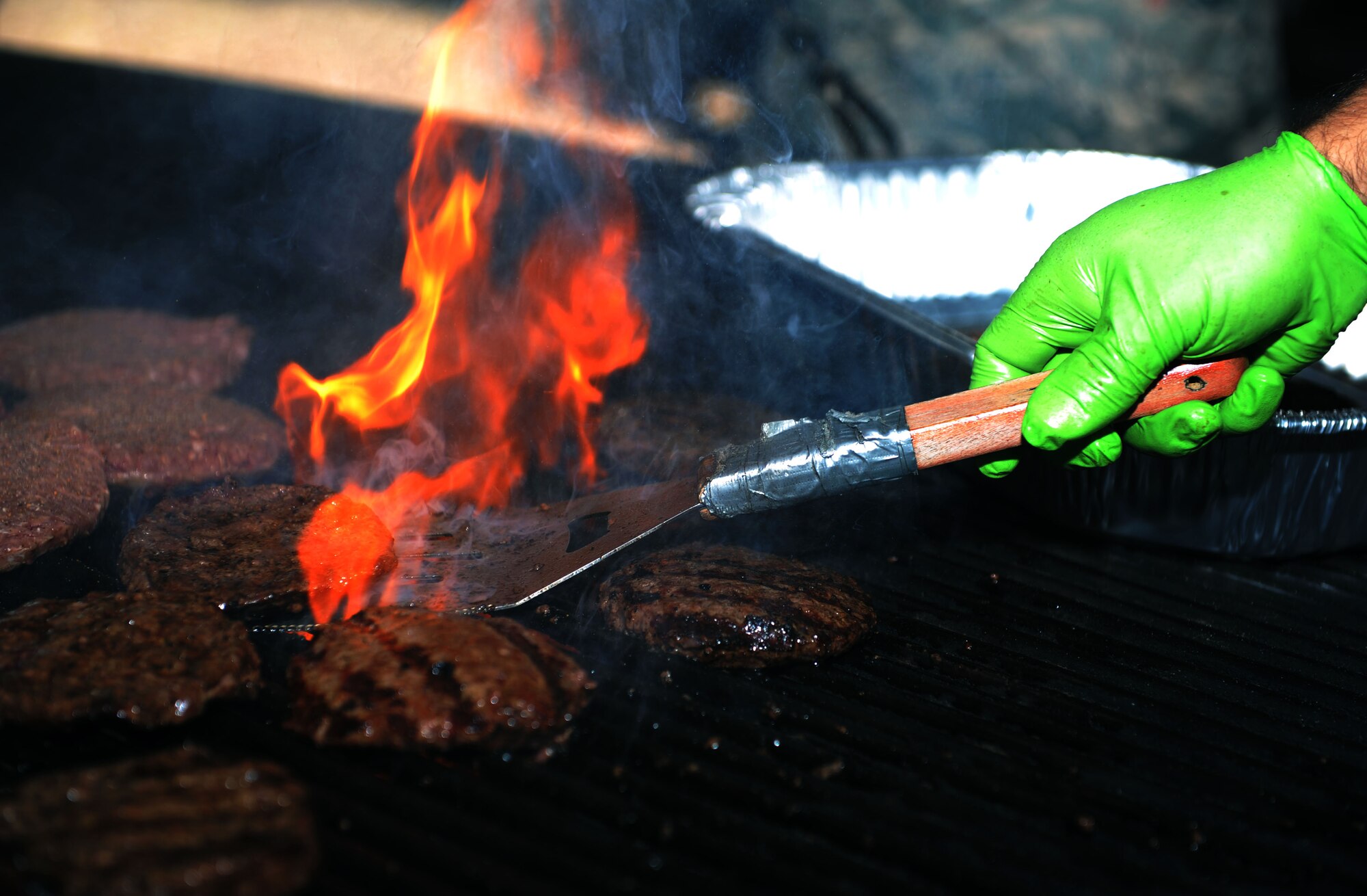 U.S. Air Force Tech. Sgt. Eric Barnes, a 52nd Component Maintenance Squadron production supervisor and grill master for the event, cooks hamburgers during the Combined Federal Campaign Overseas kickoff at the base pavilion on Spangdahlem Air Base, Germany, Sept. 21, 2015. Base community members consumed hot dogs, hamburgers, chips and beverages provided to them by the CFC-O event coordinators and squadron representatives. The campaign’s mission is to promote and support philanthropy through a program that is employee-focused, cost-efficient and effective in providing all federal employees the opportunity to improve the quality of life for all. (U.S. Air Force photo by Airman 1st Class Timothy Kim/Released)