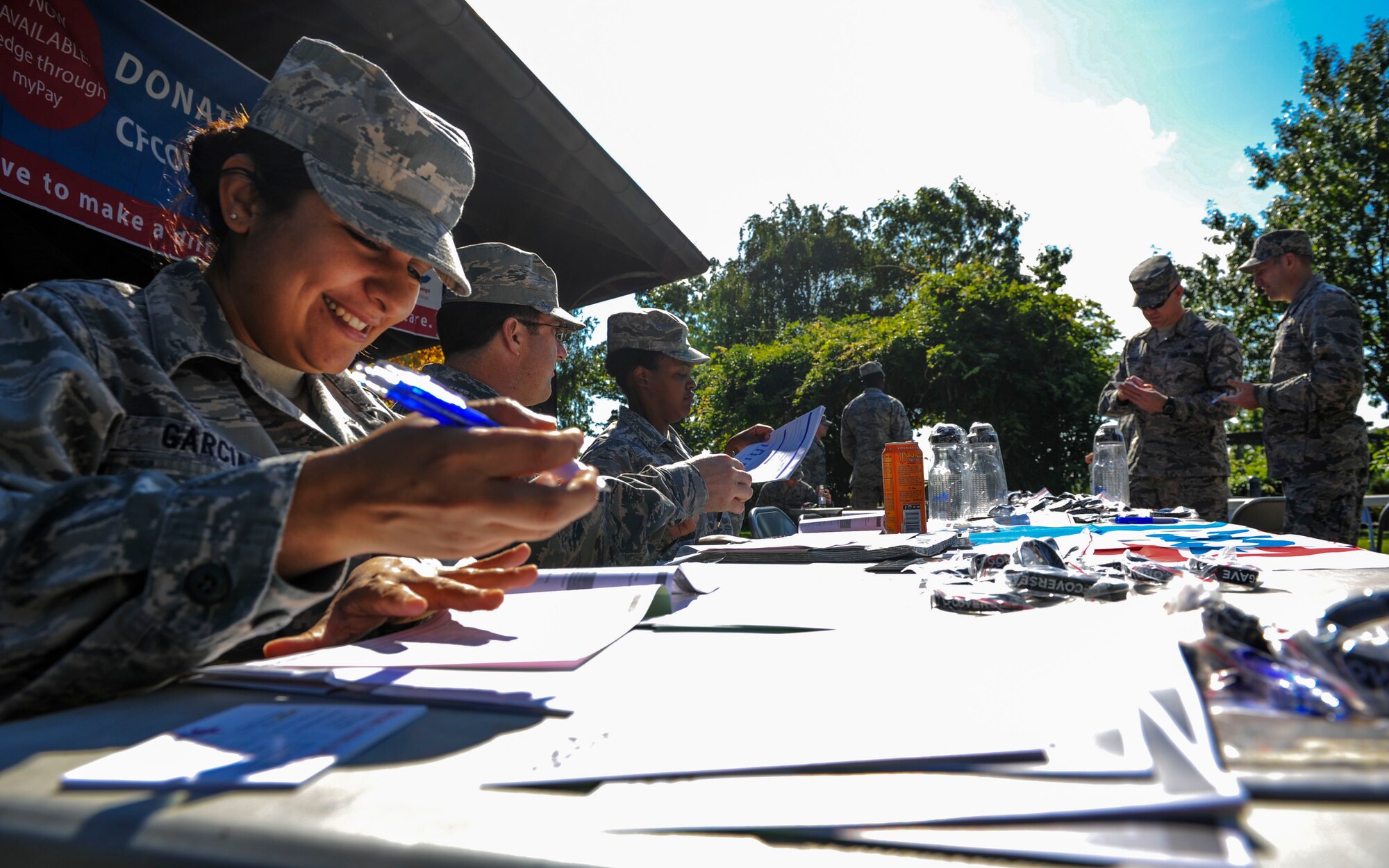 Event coordinators and volunteers set up a sign-up table for the Combined Federal Campaign Overseas kickoff at the base pavilion on Spangdahlem Air Base, Germany, Sept. 21, 2015. Nearly 40 base members attended the kickoff and gave donations during the event. The campaign’s mission is to promote and support philanthropy through a program that is employee-focused, cost-efficient and effective in providing all federal employees the opportunity to improve the quality of life for all. (U.S. Air Force photo by Airman 1st Class Timothy Kim/Released)