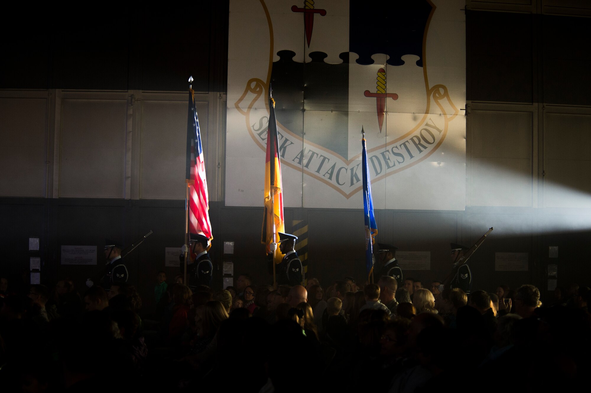 Members of Tops in Blue present the colors before the start of a performance in Hangar 1 at Spangdahlem Air Base, Germany, Sept. 22, 2015. Airmen stationed worldwide compete in a multi-level competition for the right to be selected as a member of Tops in Blue, the Air Force’s Expeditionary Entertainment Unit. (U.S. Air Force photo by Airman 1st Class Luke Kitterman/Released)