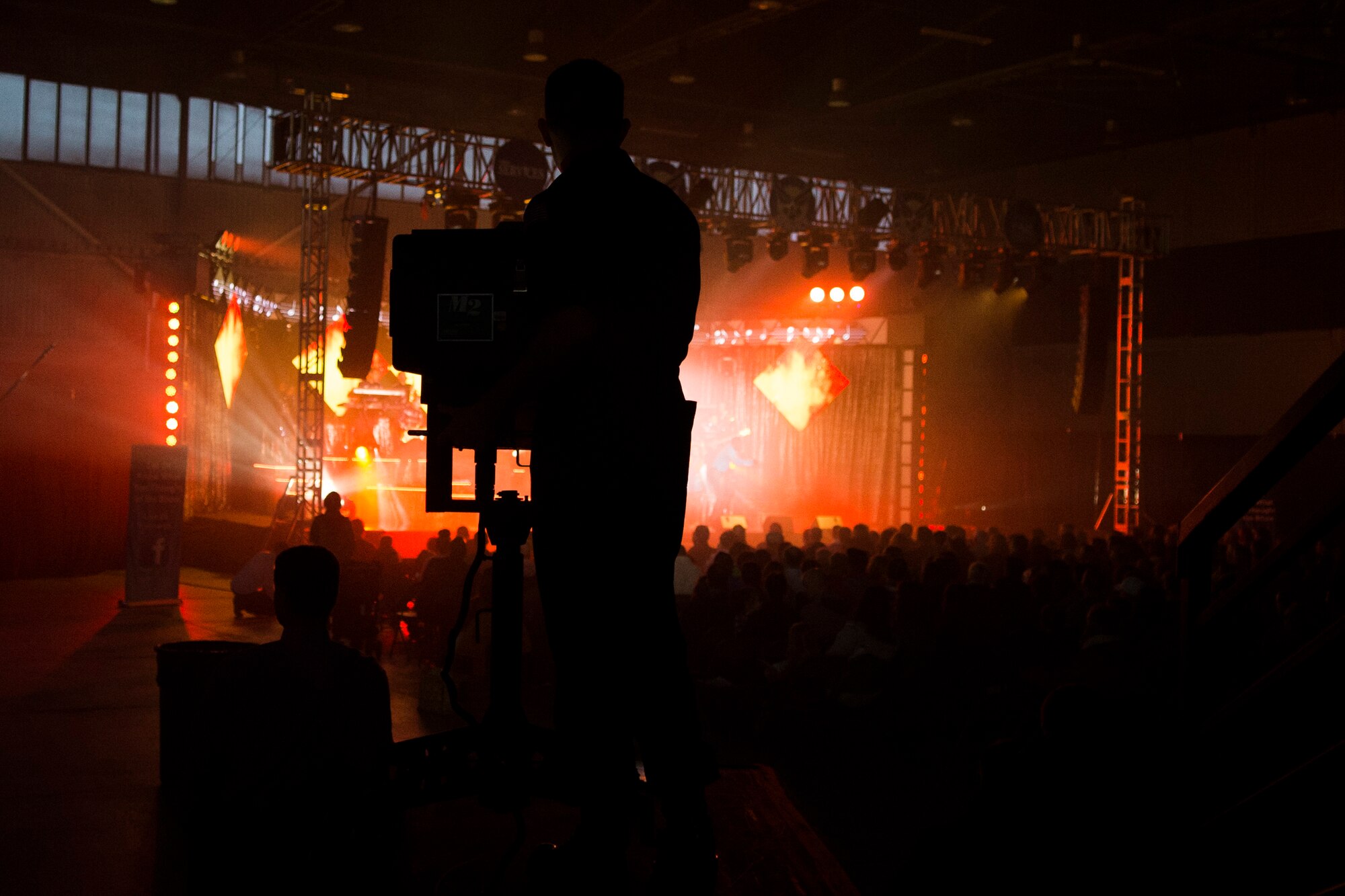 U.S. Air Force Airman Senior Airman Mason Hack, 52nd Logistics Readiness Squadron vehicle operator, operates a spotlight during a performance in Hangar 1 at Spangdahlem Air Base, Germany, Sept. 22, 2015. Tops in Blue is the Air Force’s Premiere Expeditionary Entertainment Unit made up of nearly 40 active-duty Airmen performing as vocalists, musicians, dancers and lighting, audio and stage technicians. (U.S. Air Force photo by Airman 1st Class Luke Kitterman/Released) 