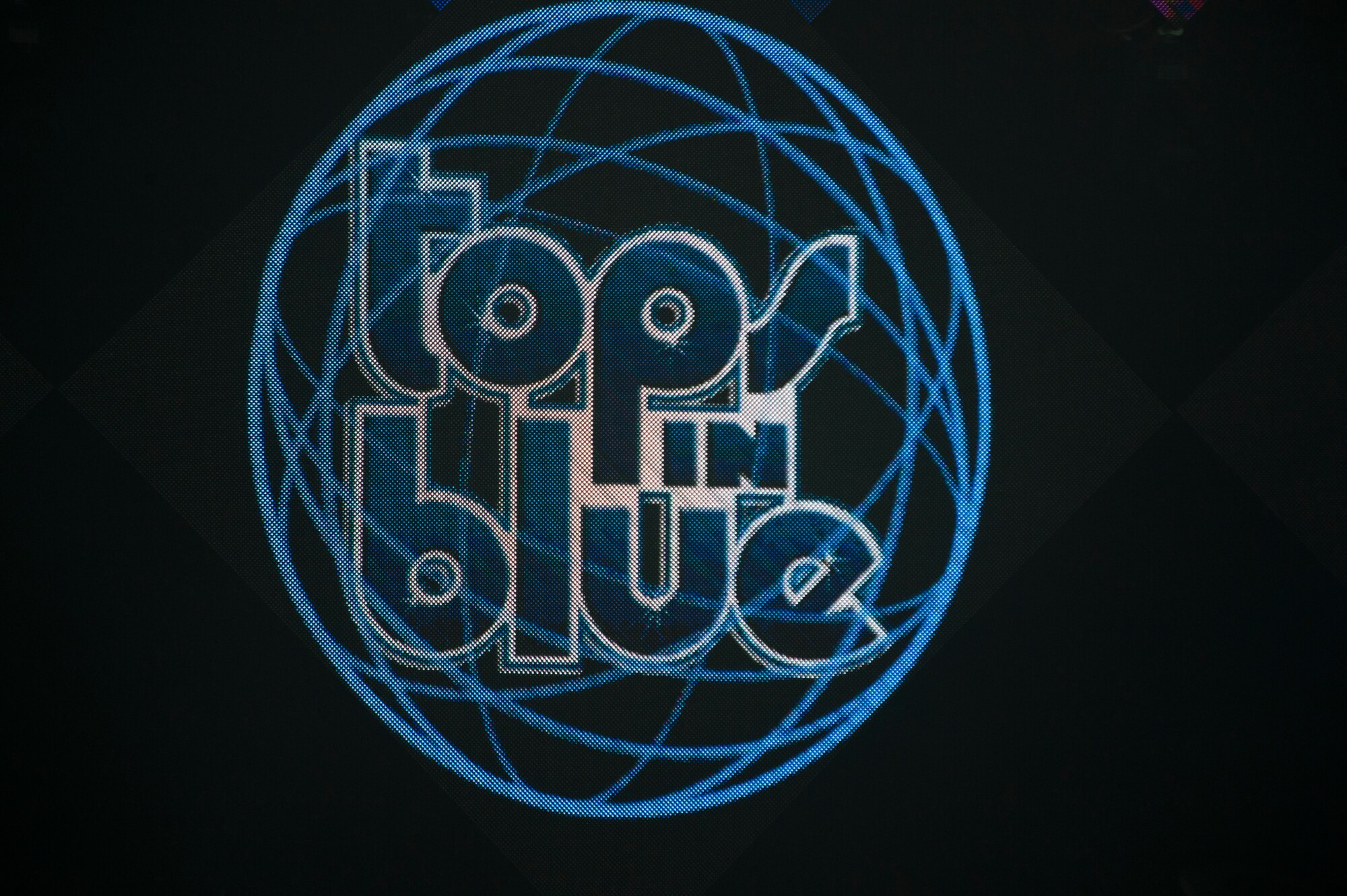 A Tops in Blue logo is displayed during a performance in Hangar 1 at Spangdahlem Air Base, Germany, Sept. 22, 2015. Tops in Blue is the Air Force’s Premiere Expeditionary Entertainment unit made up of nearly 40 active-duty Airmen performing as vocalists, musicians, dancers and lighting, audio and stage technicians. (U.S. Air Force photo by Airman 1st Class Luke Kitterman/Released) 
