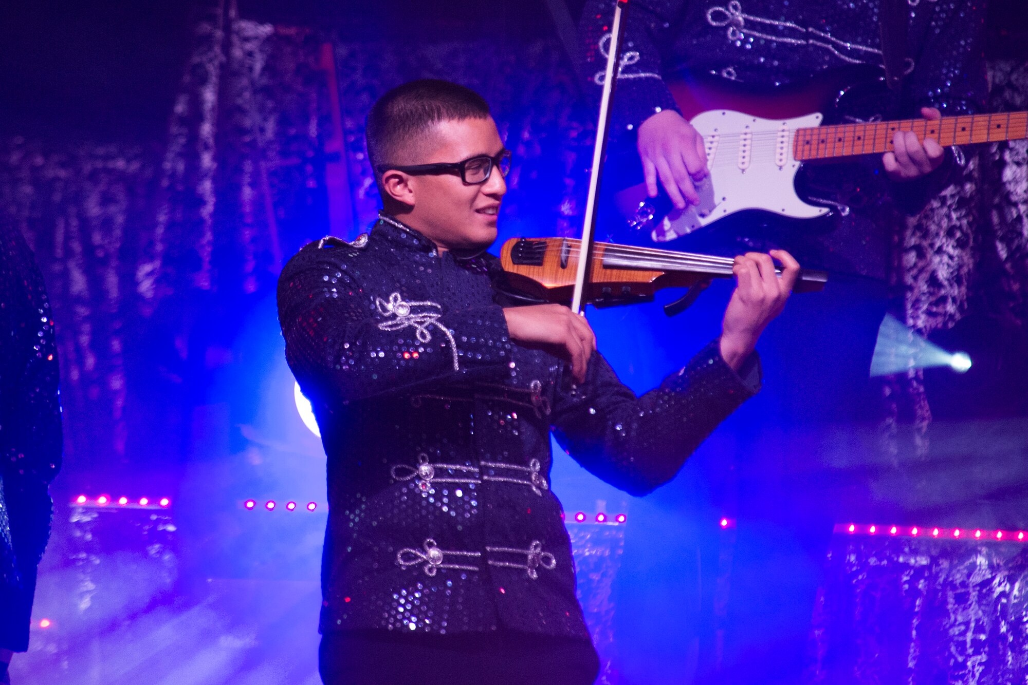U.S. Air Force 1st Lt. Oliver Chang, a Tops in Blue team member, plays the violin during a performance by Tops in Blue in Hangar 1 at Spangdahlem Air Base, Germany, Sept. 22, 2015. The group performed musical and dancing skits covering multiple genres and time periods. Chang is a Space and Missile Systems Center developmental engineer out of Los Angeles Air Force Base, Calif. (U.S. Air Force photo by Airman 1st Class Luke Kitterman/Released) 
