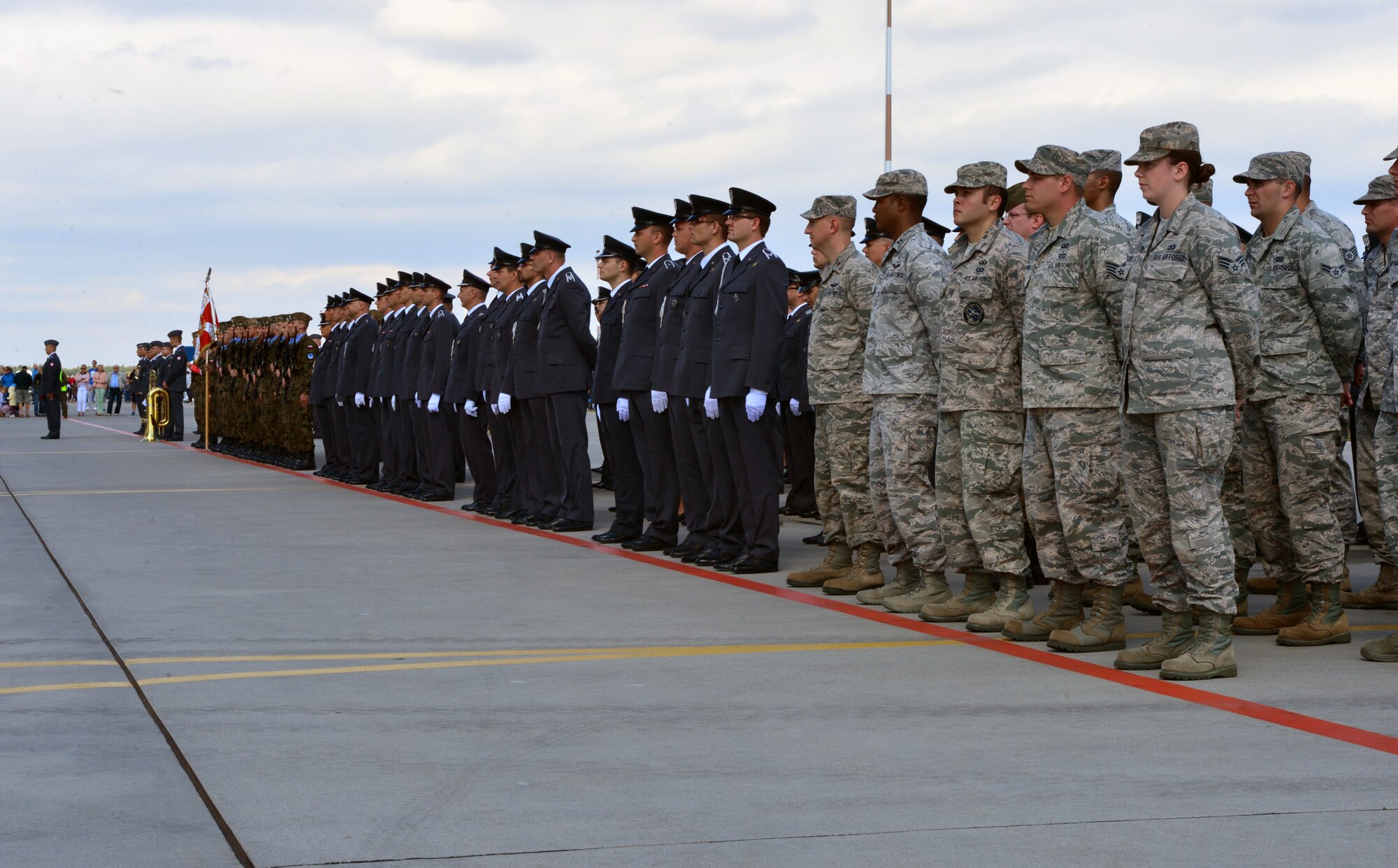 Airmen from the 606th Air Control Squadron stand in formation with Polish airmen from the 31st Tactical Air Base during the Feast of the 31st Tactical Air Base Poznań-Krzesiny ceremony at Krzesiny Air Base, Poland Sept. 5, 2015. This year marked the first time United States service members marched in the ceremony’s official formation. (U.S. Air Force photo by 2nd Lt. Meredith Mulvihill/Released)