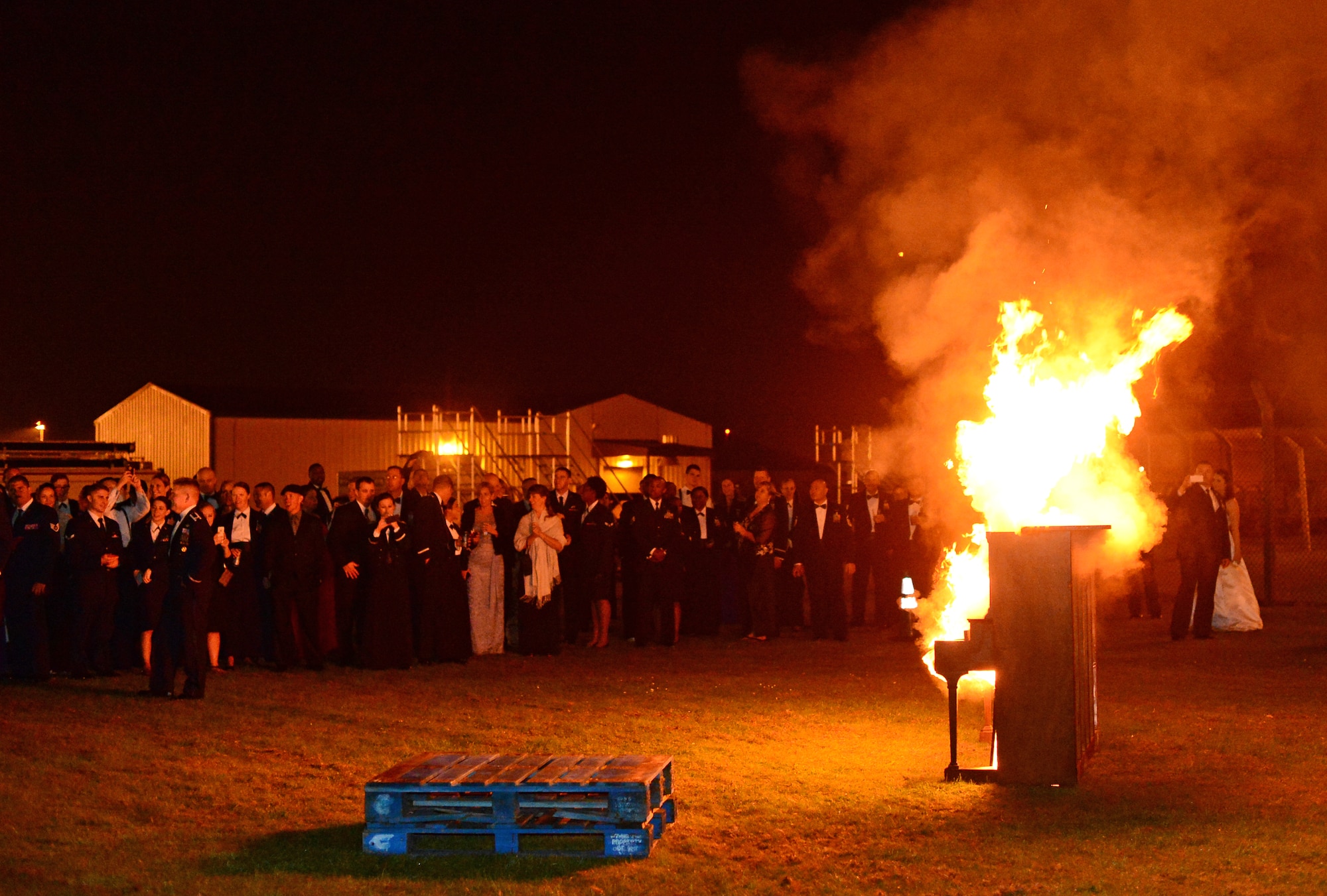 Service and family members watch a piano burn during the Air Force Ball at Royal Air Force Lakenheath, England, Sept. 18, 2015. The burning of a piano is a long-standing tradition in the RAF. (U.S. Air Force photo by Senior Airman Erin O’Shea/Released) 
