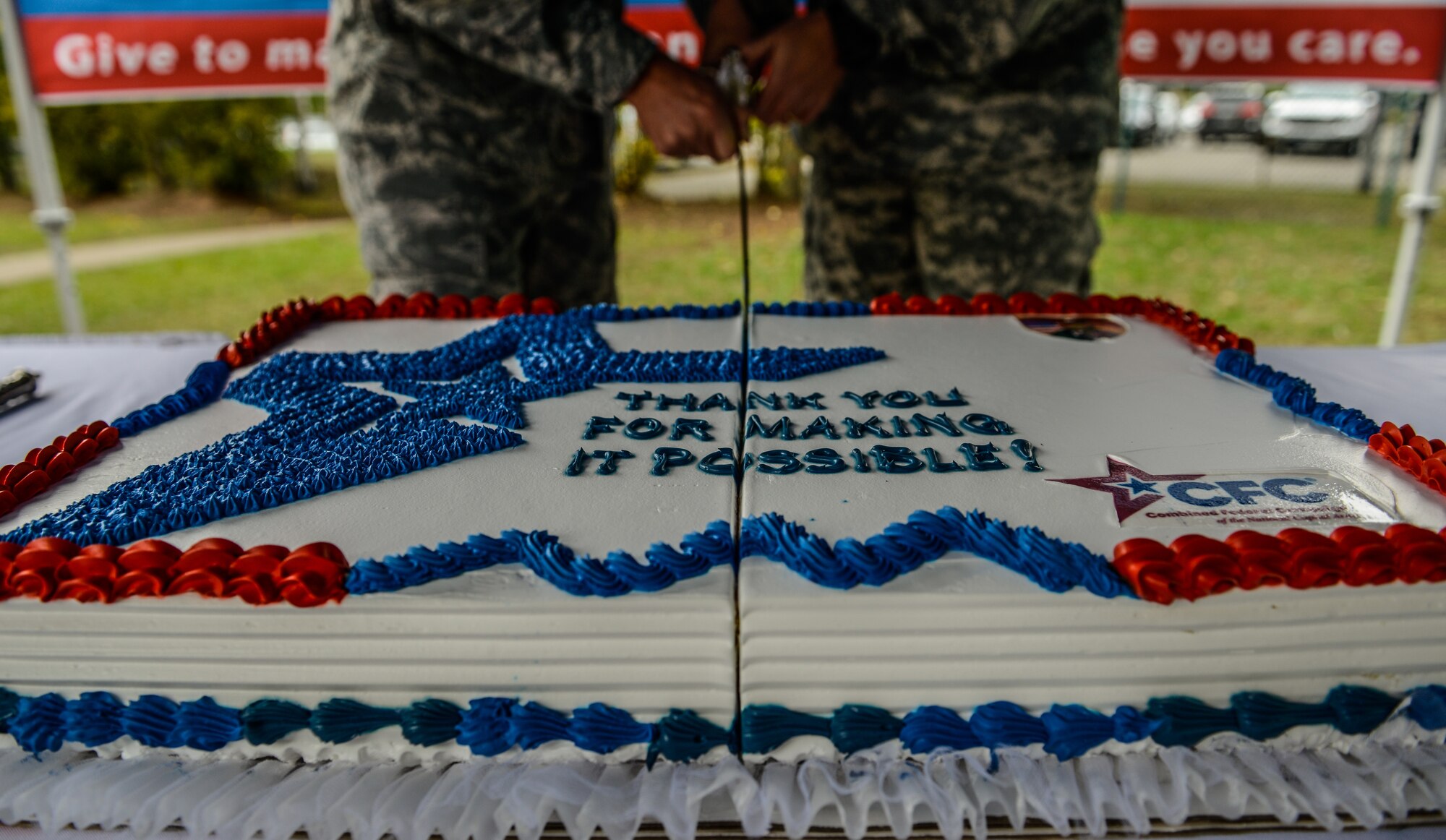 Brig. Gen. Jon T. Thomas, 86th Airlift Wing commander, and Col. G. Shawn Wells, U.S. Army Garrison Rheinland-Pfalz commander, cut a cake during the opening ceremony of the Combined Federal Campaign-Overseas kickoff Sept. 15, 2015, on Vogelweh Military Complex, Germany. The CFC-O holds an annual fundraiser that helps commanders improve quality of life programs for service members. (U.S. Air Force photo/Senior Airman Nicole Sikorski)