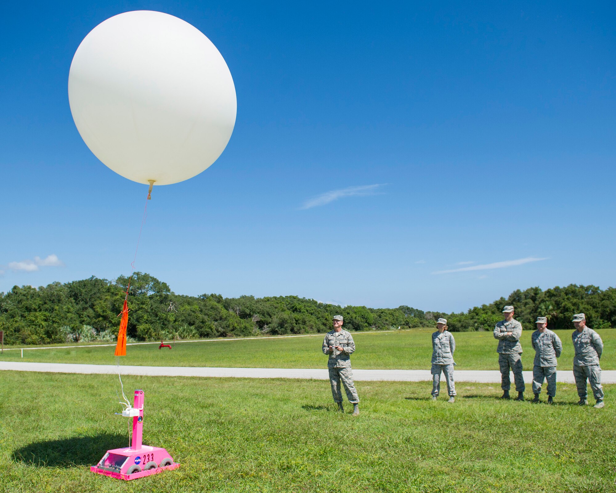 Brig. Gen. Wayne Monteith, 45th Space wing commander, controls the release of a weather balloon from the ‘weather-bot’ Sept. 22, 2015, while members of the 45th Operations Group look on at Cape Canaveral Air Force Station, Florida. The wing commander met with the personnel from 45th OG and was introduced to the facilities they use in daily operations. (U.S. Air Force photo byMatthew Jurgens/Released)