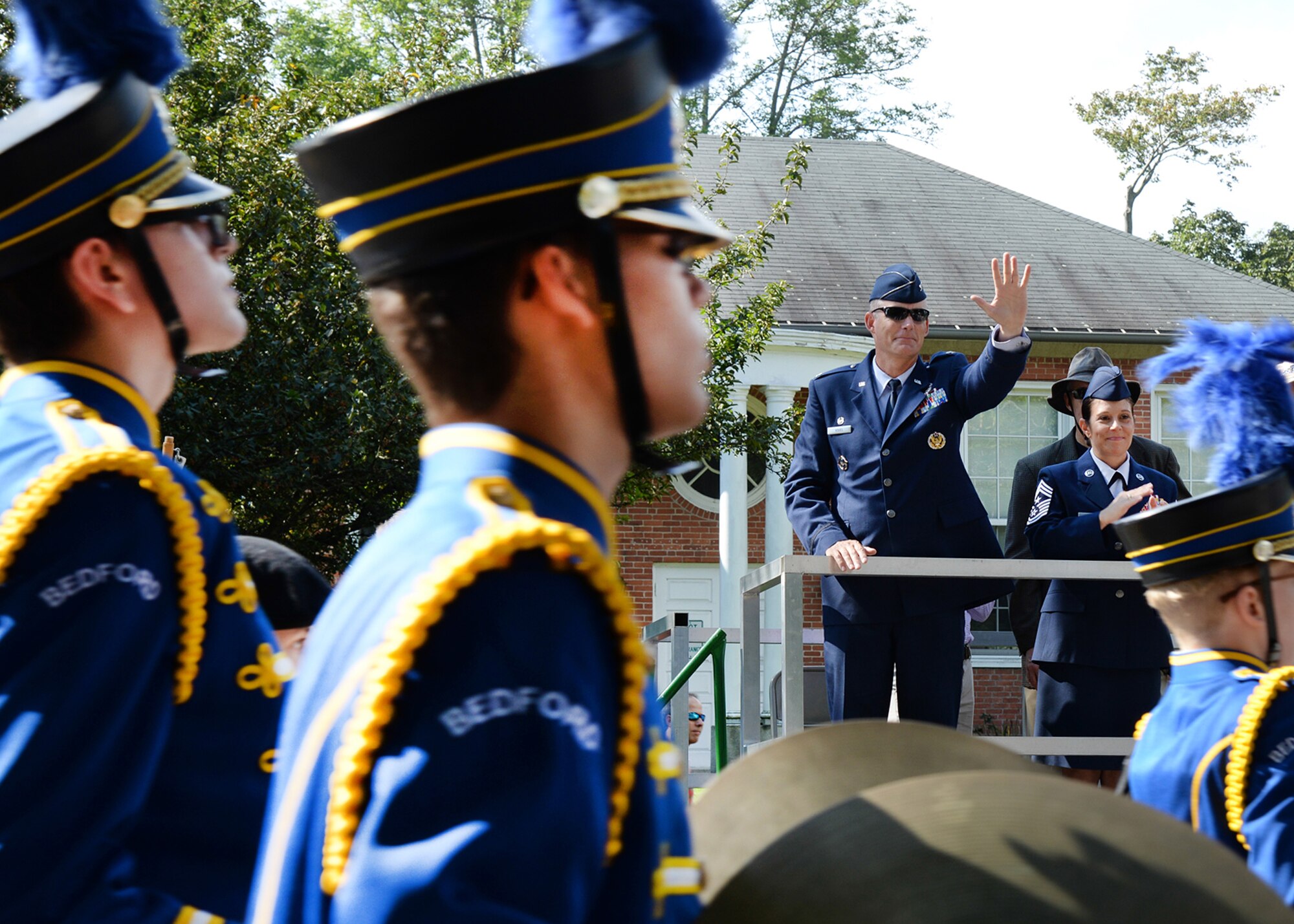 Col. Michael A. Vogel, 66th Air Base Group commander, and Hanscom Command Chief Master Sgt. Patricia L. Hickey, wave to members of the local community marching in the Bedford Day parade Sept. 19. The annual event celebrated the 286th anniversary of the town's establishment. (U.S. Air Force photo by Linda LaBonte Britt)
