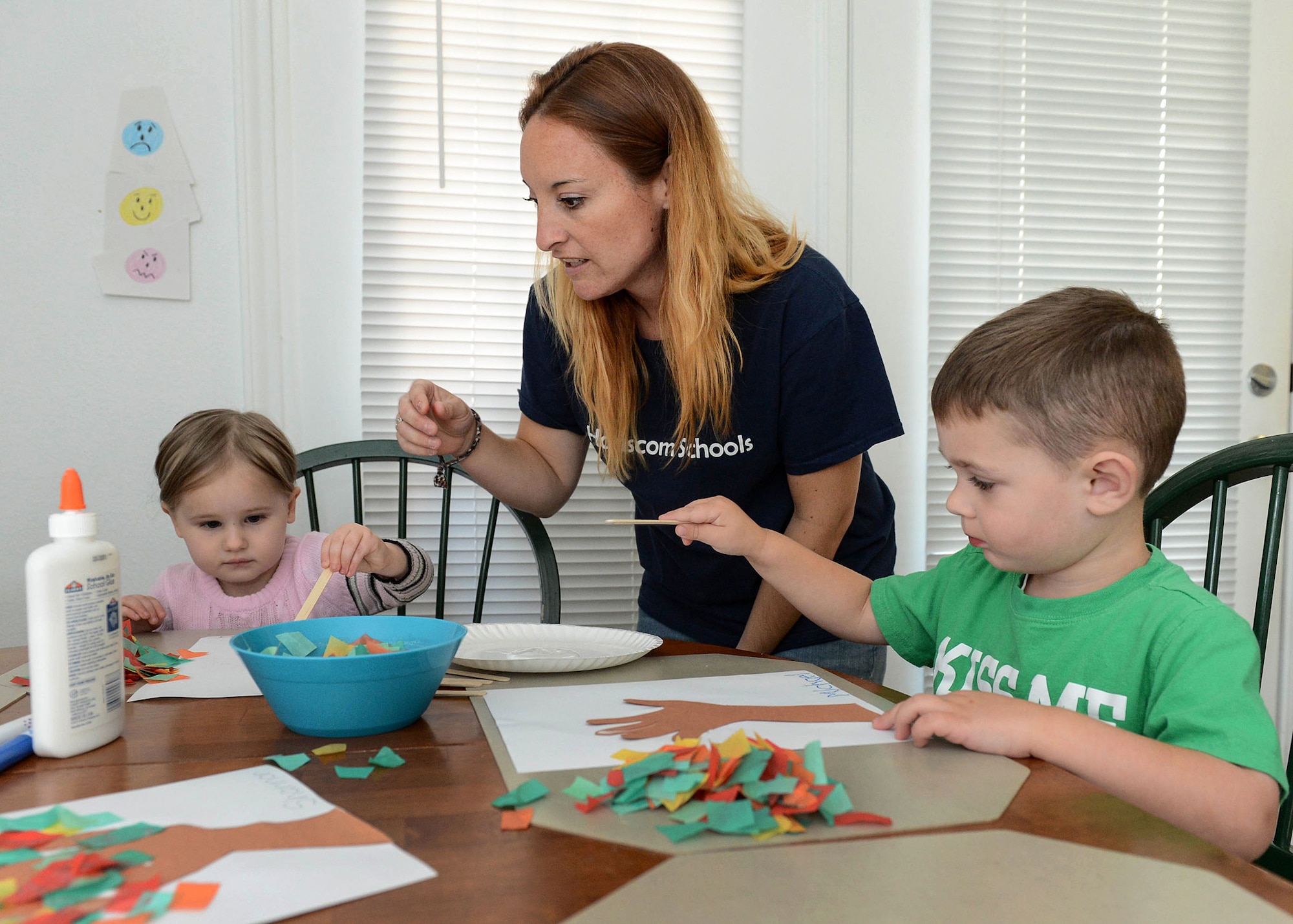 Amber Krofta, a Family Child Care provider, helps Anya Zamzow, right, and Michael Krohn, left, Sept. 21 during play time at her house where she cares for children. Family Child Care program is actively recruiting individuals in base housing who wish to become child care professionals. (U.S. Air Force photo by Jerry Saslav)
