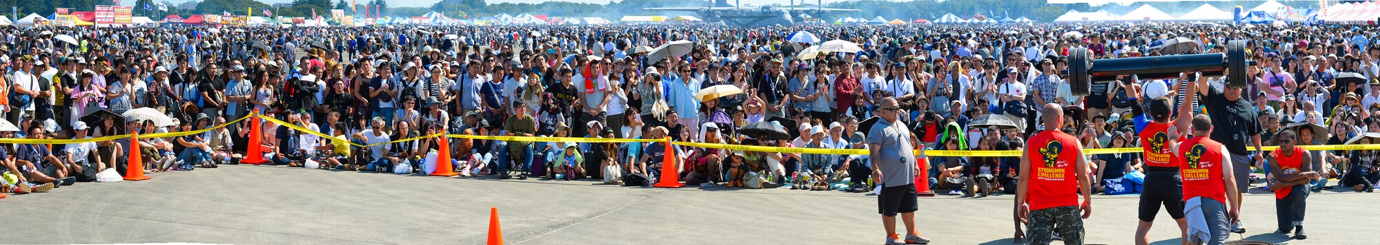 Spectators observe a contestant in the Strong Man Competition during the Japanese-American Friendship Festival at Yokota Air Base, Japan, Sept. 20, 2015. The festival hosted a variety of events including musicians, competitions, traditional dance and fireworks. This panoramic was created in Photoshop using the photomerge tool. (U.S. Air Force photo illustration by Airman 1st Class Elizabeth Baker/Released)
