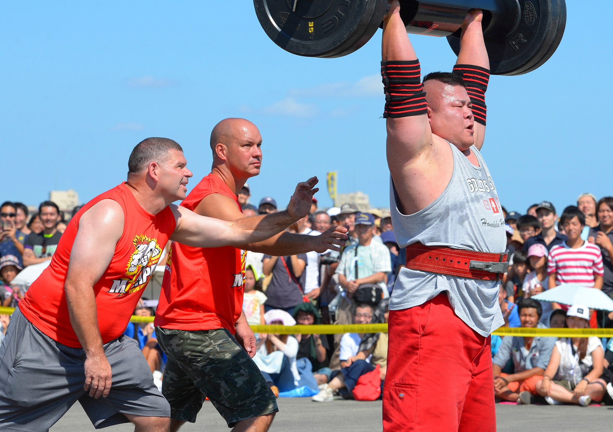 A contestant in the Strong Man Competition lifts weight over his head during the 2015 Japanese-American Friendship Festival at Yokota Air Base, Japan, Sept. 20, 2015. Events such as musicians, competitions, traditional dance and fireworks entertained the crowds. (U.S. Air Force photo by Airman 1st Class Elizabeth Baker/Released)