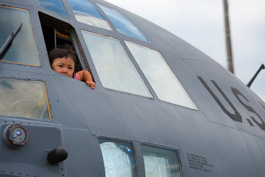 A child looks out the window of a C-130 Hercules during the Japanese-American friendship festival at Yokota Air Base, Japan, Sept. 20, 2015. Yokota invited visitors to explore the inside of some of the aircraft on display at the festival. (U.S. Air Force photo by Airman 1st Class Elizabeth Baker/Released)