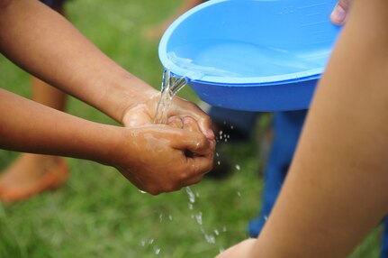 SOTO CANO AIR BASE, Honduras – A child washes her hands at a hygiene demonstration in Calavera Centro, Honduras, during the 63rd Joint Task Force-Bravo Chapel Hike Sept. 19, 2015. A humanitarian assistance, volunteer event, the Hike included the distribution of 11,500 pounds of donated goods, as well as other events intend to promote the health and morale of families in this remote, mountain village. (U.S. Air Force photo by Capt. Christopher Love)