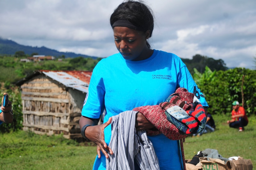 SOTO CANO AIR BASE, Honduras – U.S. Air Force Staff Sgt. Ashley Ishmon, Joint Task Force-Bravo Legal Office non-commissioned officer in charge, sorts donated clothes before distributing them to the villagers of Calavera Centro, Honduras, as part of JTF-Bravo’s 63rd Chapel Hike, Sept. 19, 2015. This was the largest Chapel Hike on record, providing 11,500 pounds of food, clothing, linen, toiletries and school supplies to the remote villagers before the onset of winter. (U.S. Air Force photo by Capt. Christopher Love)