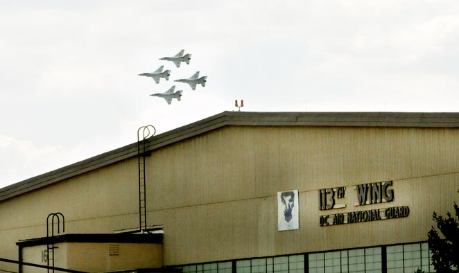 The USAF Thunderbirds air demonstration team performs a diamond formation above Joint Base Andrews, Md., as part of the Andrews Air Show Sept. 18. In the foreground is the 113th Wing, D.C. Air National Guard's maintenance hangar. (U.S. Air National Guard photo by Master Sgt. Craig Clapper)