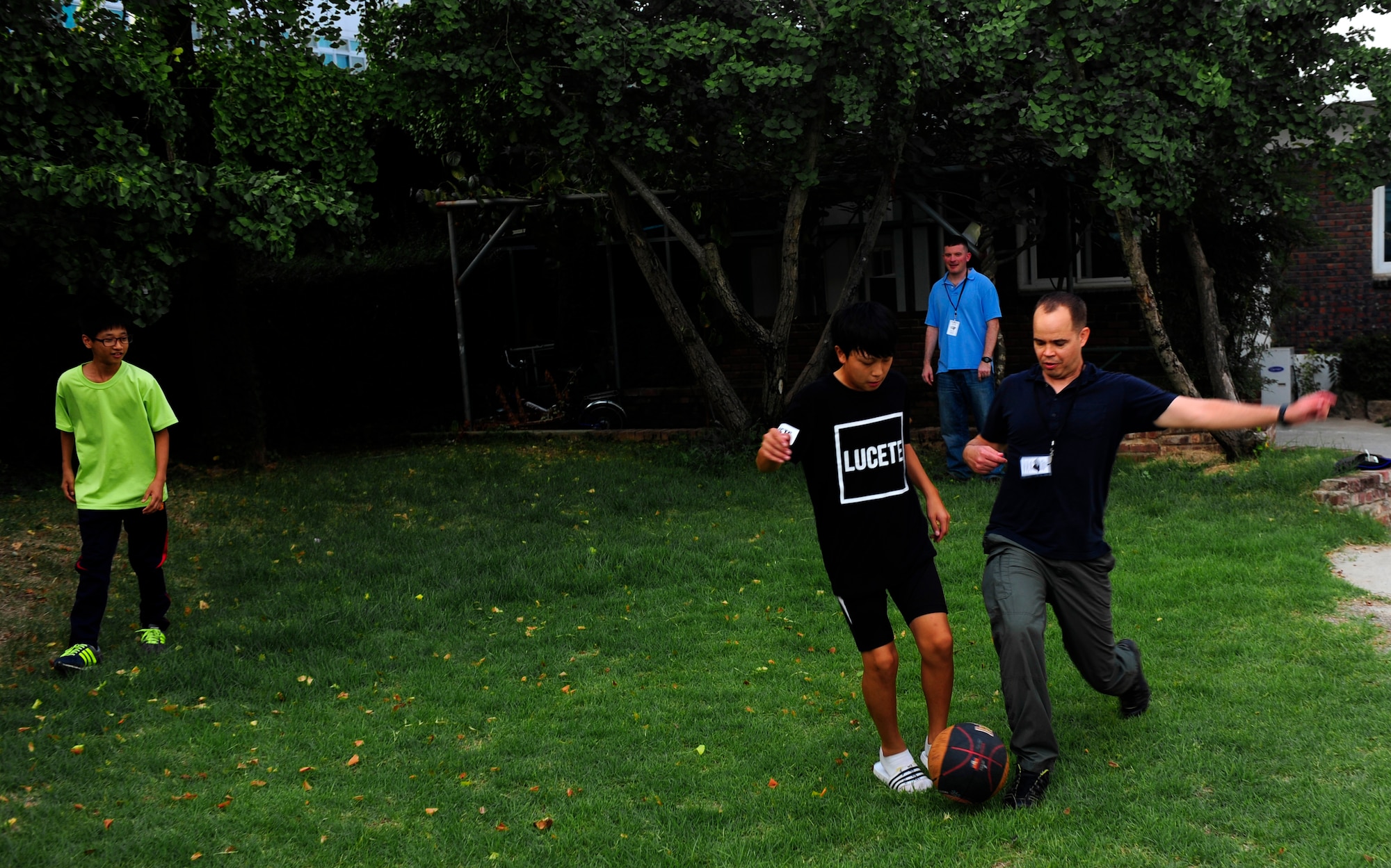 Lt. Col. Brandon Eskam, 175th Expeditionary Fighter Squadron inspector general, South Dakota Air National Guard, plays soccer with a child at a Welfare Facility in Gunsan City, ROK, Sept. 1. 2015. Airmen from Kunsan Air Base visit the orphanage monthly to bolster relationships with the local community. (U.S. Air Force photo by Staff Sgt. Nick Wilson/Released)