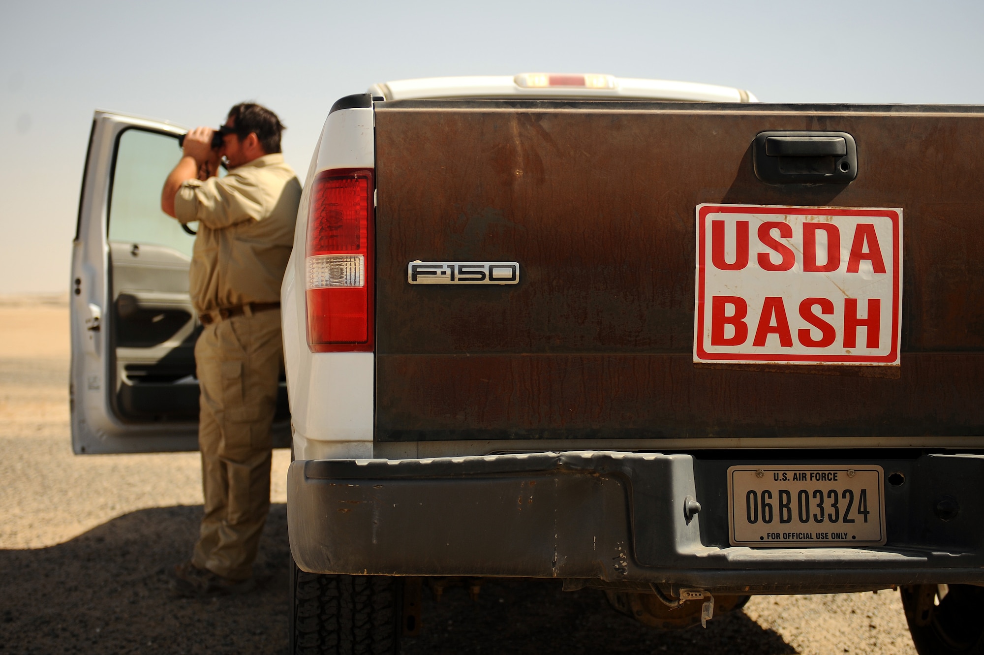 Dave Tresham, United States Department of Agriculture wildlife biologist, observes bird patterns near the flightline at an undisclosed location in Southwest Asia, Sept. 3, 2015. Tresham runs the Bird Aircraft Strike Hazard program on the base and monitors and bird and wildlife activity in the area to mitigate and reduce threats to aircraft supporting Operation Inherent Resolve. (U.S. Air Force photo/Tech. Sgt. Brittany E. Jones)