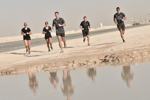 Teams were given their final times as they entered a mud pool at the end of the Diversity Day mud run September 20, 2015 at Al Udeid Air Base, Qatar. The mud run challenged 106 runners with a two mile course that contained several obstacles from low crawling, T-wall climbing, barrier hurdles, and a Ôdeep freezeÕ cold mud pool. The event was held to help spread the word of Diversity Day, an initiative started by the Department of Defense for diversity events held throughout the year. (U.S. Air Force photo/ Staff Sgt. Alexandre Montes)  