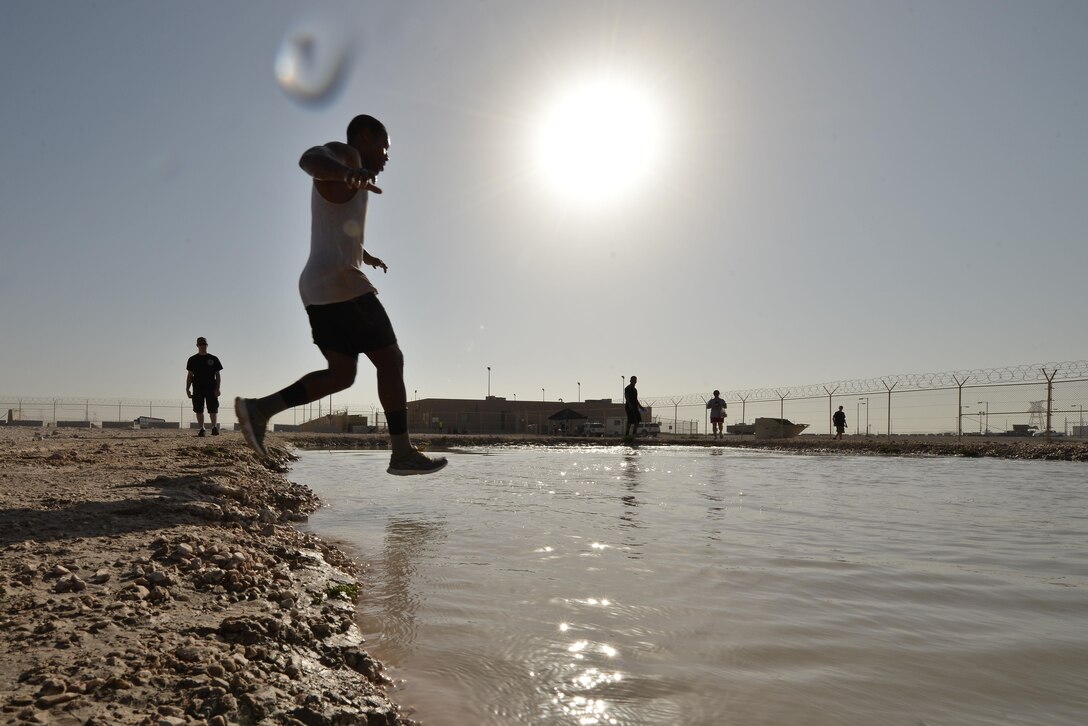 Teams were given their final times as they entered a mud pool at the end of the Diversity Day mud run September 20, 2015 at Al Udeid Air Base, Qatar. The mud run challenged 106 runners with a two mile course that contained several obstacles from low crawling, T-wall climb, barrier hurdles, and Ôdeep freezeÕ cold mud pool. The event was held to help spread the word of Diversity Day, an initiative started by the Department of Defense for events held throughout the year. (U.S. Air Force photo/ Staff Sgt. Alexandre Montes)  