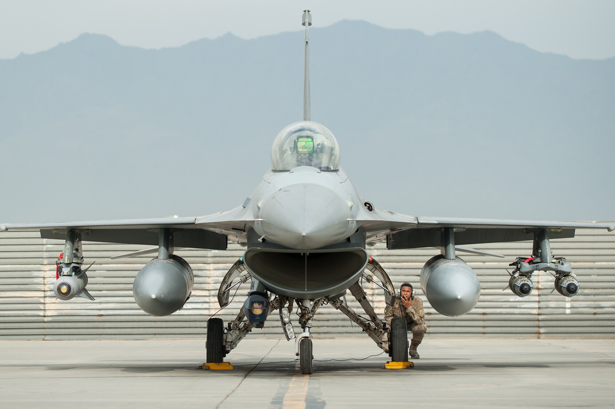 A U.S. Airman assigned to the 455th Expeditionary Maintenance Squadron and an F-16 Fighting Falcon pilot assigned to the 555th Expeditionary Fighter Squadron go over a pre-flight inspection before a combat sortie from Bagram Airfield, Afghanistan, Sept. 22, 2015. The F-16 is a multi-role fighter aircraft that is highly maneuverable and has proven itself in air-to-air and air-to-ground combat. (U.S. Air Force photo by Tech. Sgt. Joseph Swafford/Released)