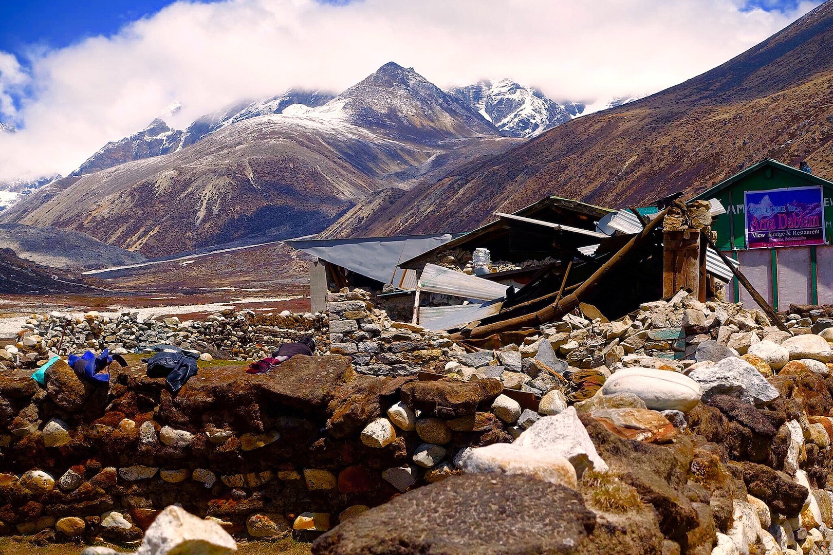 Mount Everest looms in the backdrop of a collapsed structure in Nepal after a magnitude 7.8 earthquake rocked the region April 25. Maj. Asif Anwar, a flight surgeon with the Wisconsin Air National Guard’s 128th Air Refueling Wing, treated more than 500 patients on Mount Everest and in Katmandu, Nepal, in the days following the earthquake. 