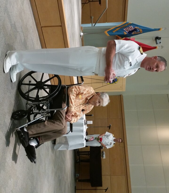 Navy Capt. Christopher Mosher, DLA Troop Support Subsistence director, presents John Bulovas, a former World War II POW, with a token of appreciation for sharing his experience during the Philadelphia Compound Veterans Committee’s annual POW/MIA Remembrance ceremony Sept. 15 in Philadelphia. Bulovas was captured in 1943 by German forces and was liberated in 1945.