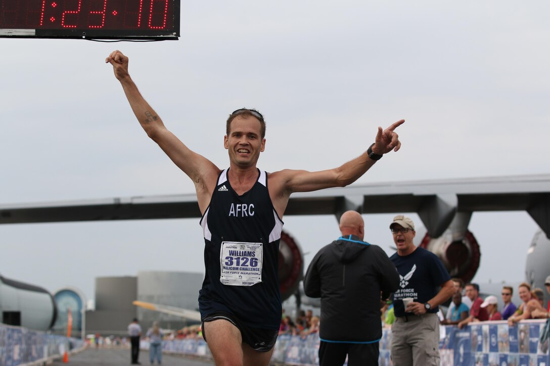 Senior Airman Josh Williams, half marathon participant, crosses the finish line in the 19th Annual Air Force Marathon held Sept. 19, 2015. Williams was a member of the Air Force Reserve Command MAJCOM Challenge Team. The team consisted of traditional reservists, air reserve technicians, individual mobilization augmentees and Air Guard Reserve members. The MAJCOM challenge included six Airmen participating in the half marathon and four in the full marathon. (U.S. Air Force photo /Tech. Sgt. Patrick O’Reilly)