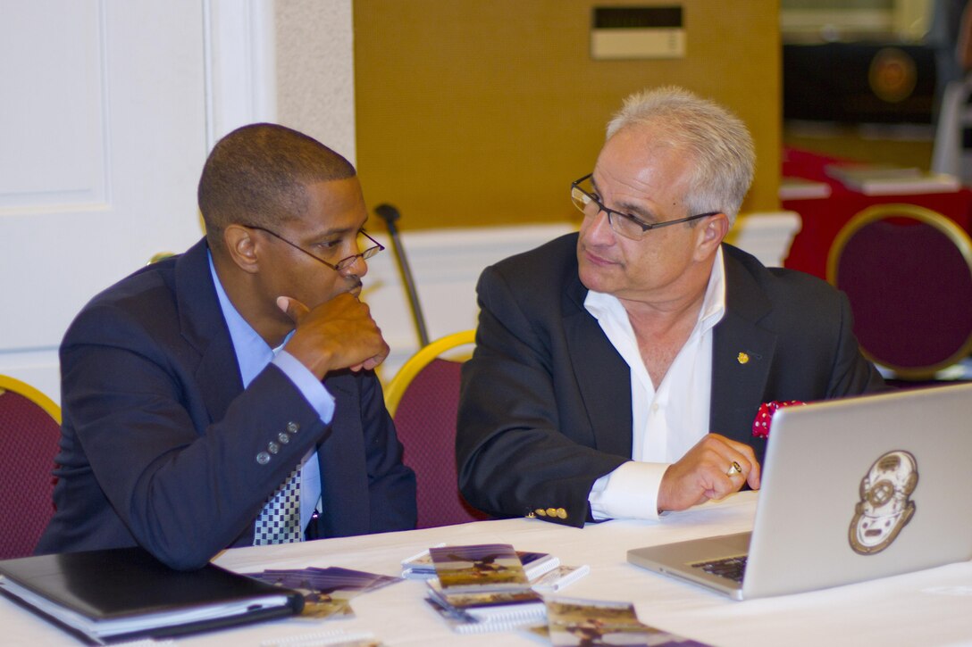 Tony Palm (R), staffing consultant, assists Army Sgt. 1st Class Lance Washington, organizational and training development, during the Marine Corps Base Quantico Hiring Event held at the Clubs of Quantico Sept. 18.