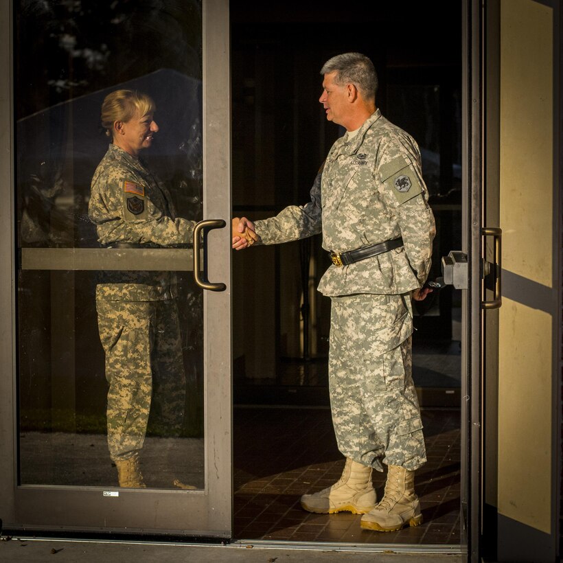 Army Reserve Maj. Gen. Leslie Purser, outgoing commander of the 108th Training Command (Initial Entry Training), shakes hands with Maj. Gen. Mark McQueen, the incoming commander, before walking onto the parade field for their change of command ceremony at Fort Jackson, S.C., Sept. 20, 2015. (U.S. Army photo by Sgt. Ken Scar)