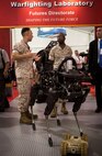 Lieutenant General Ronald L. Bailey (right), Deputy Commandant Plans, Polices, and Operations, and Captain Jim Pineiro (left), MCWL/FD Science and Technology Ground Combat Element branch head discuss the possible applications of the small robotic quadruped called Spot. The state-of-the-art robot could play an important role in MCWL/FD's continued exploration into unmanned systems and how they will shape tomorrow's future force.
