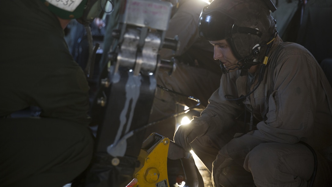 Marines with Marine Heavy Helicopter Squadron 466 inspect the hooks in a CH-53E Super Stallion at Marine Corps Air Station Miramar, Calif., Sept. 16. Marines with HMH-466 prepared to conduct nighttime external-lift training at Marine Corps Base Camp Pendleton, Calif. 