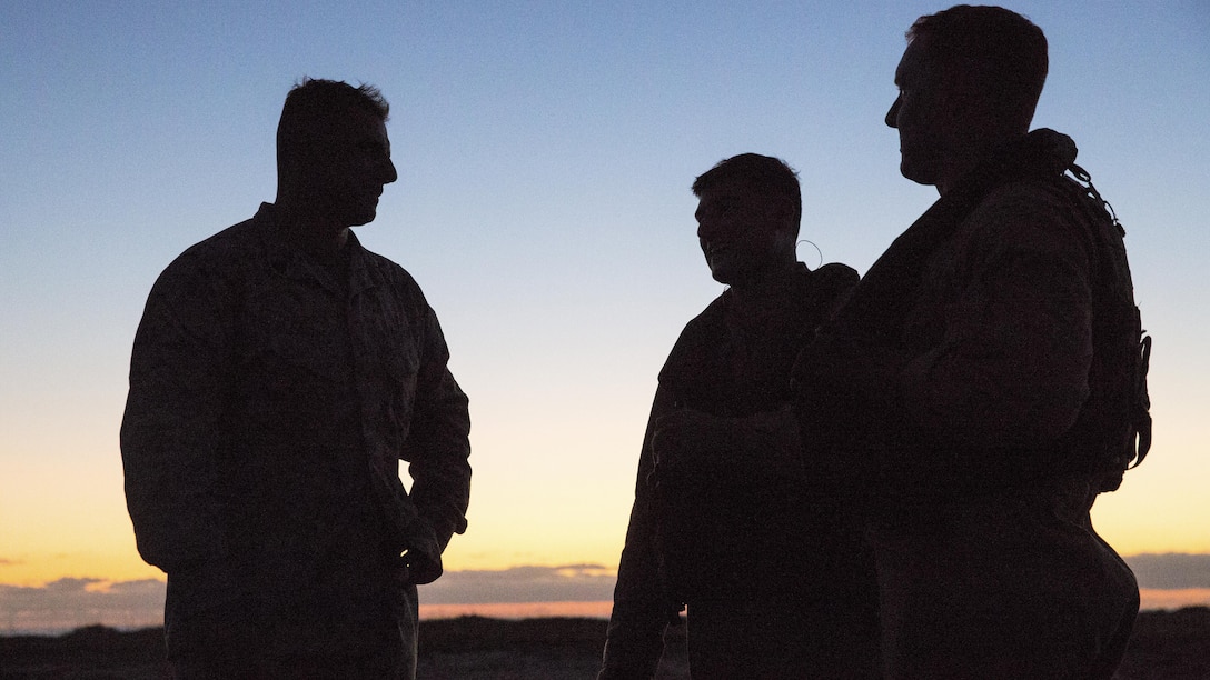 Pilots with Marine Heavy Helicopter Squadron 466 speak with a range safety officer at Marine Corps Base Camp Pendleton, Calif., Sept. 16. Marines with Combat Logistics Battalion 1 and HMH-466 conducted external-lift training during the night. (