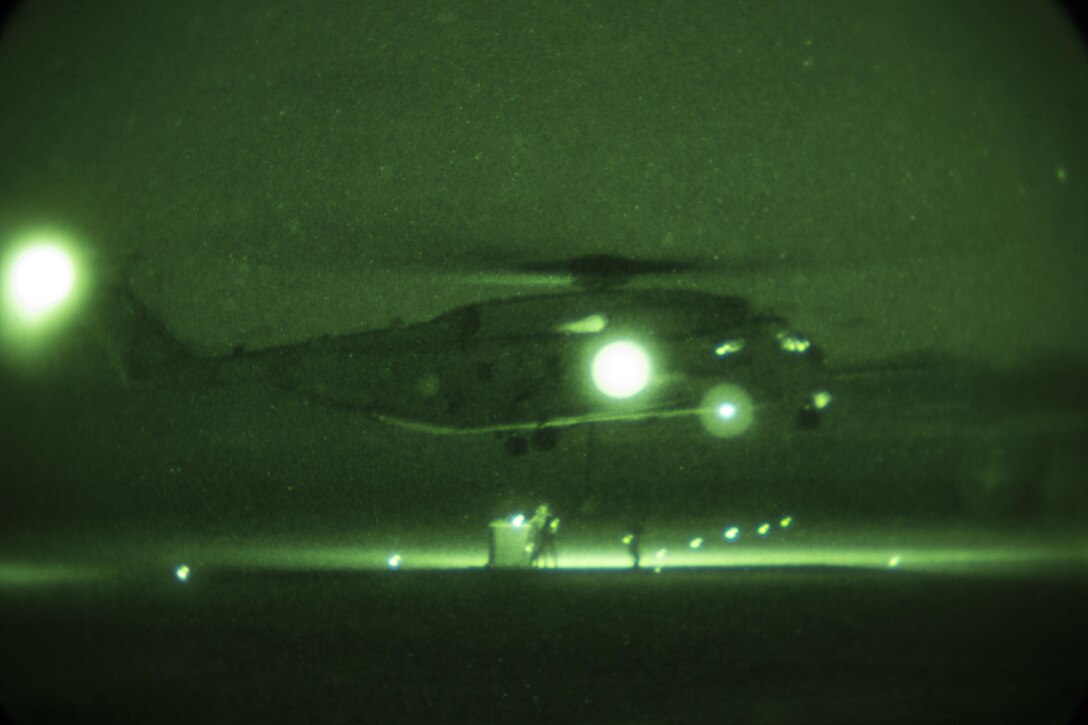 A CH-53E Super Stallion with Marine Heavy Helicopter Squadron 466 hovers over a load during nighttime external-lift training aboard Marine Corps Base Camp Pendleton, Calif., Sept. 16. Marines with Combat Logistics Battalion 1 and HMH-466 cooperated to secure and lift an external load of 10,000 pounds. 