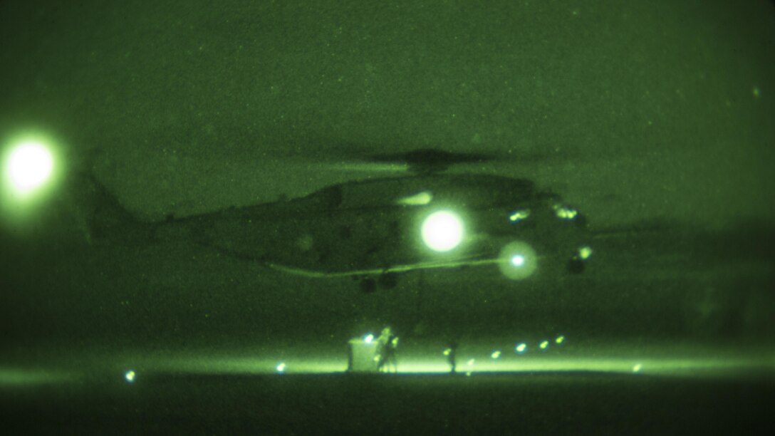 A CH-53E Super Stallion with Marine Heavy Helicopter Squadron 466 hovers over a load during nighttime external-lift training at Marine Corps Base Camp Pendleton, Calif., Sept. 16. Marines with Combat Logistics Battalion 1 and HMH-466 cooperated to secure and lift an external load of 10,000 pounds. 