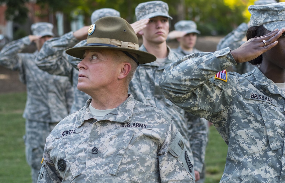 Army Reserve drill sergeant, Staff Sgt. Blake Howell of Belton, S.C., inspects the arm and hand positions of Clemson University Reserve Officer Training Corps cadets while teaching them the proper way to salute during a drill and ceremony lab conducted by drill sergeants from the division on Clemson’s Bowman Field, Sept. 3, 2015. (U.S. Army photo by Sgt. Ken Scar)