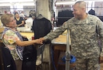 DLA senior enlisted leader Army Command Sgt. Maj. Charles Tobin, left, shakes hands with the longest-working employee at DeRossi & Son in Vineland, N.J., with 55 years on the job, during a visit to the Clothing and Textiles vendor’s facility Aug. 19. Tobin also visited Crown Clothing in Vineland and the Federal Correctional Institution at Joint Base McGuire-Dix-Lakehurst, N.J.