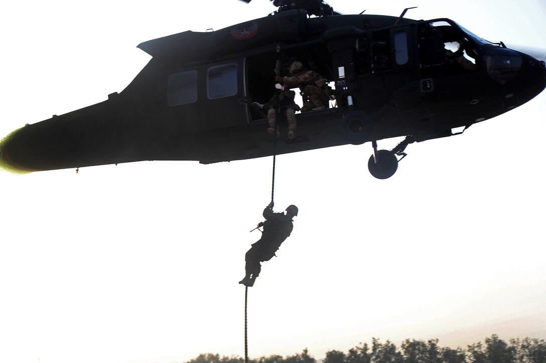 U.S. soldiers fast-rope from a UH-60 Black Hawk helicopter during air assault training on Jalalabad Airfield in eastern Afghanistan, Sept. 16, 2015. The soldiers are assigned to the 101st Airborne Division's 3rd Brigade Combat Team. U.S. Army photo by Capt. Charles Emmons