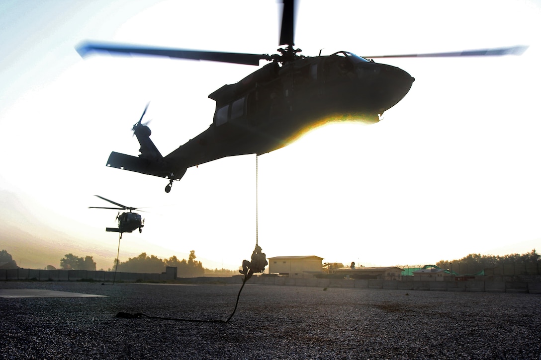 U.S. soldiers fast-rope from UH-60 Black Hawk helicopters during air assault training on Jalalabad Airfield in eastern Afghanistan, Sept. 16, 2015. The soldiers are assigned to the 101st Airborne Division's 3rd Brigade Combat Team. U.S. Army photo by Capt. Charles Emmons