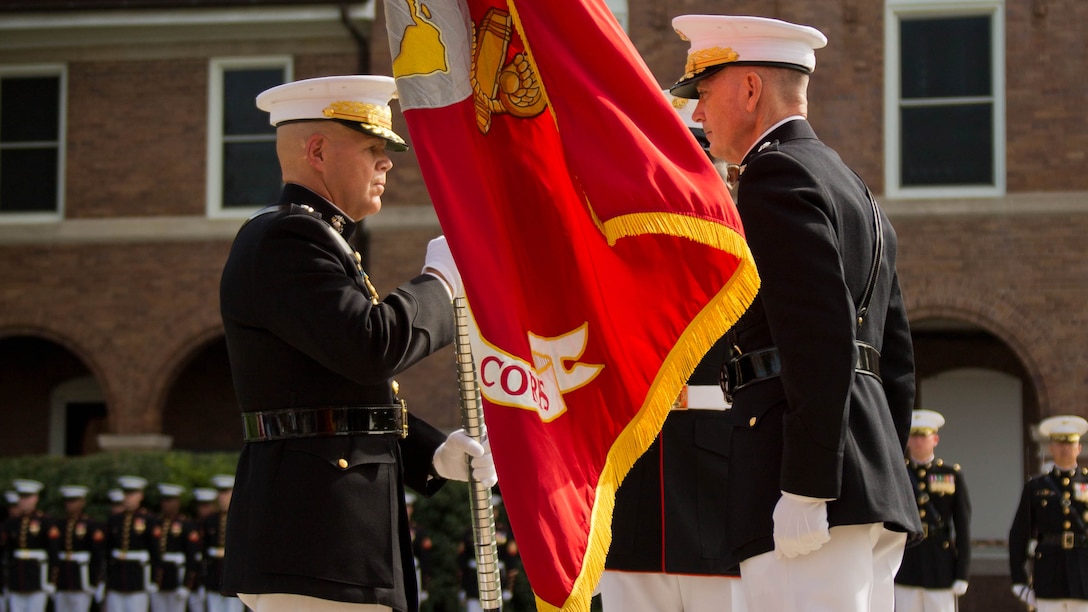 The 37th Commandant of the Marine Corps, Gen. Robert B. Neller, left, receives the Marine Corps Colors from Gen. Joseph F. Dunford, Jr., during the Passage of Command ceremony at Marine Barracks Washington, Washington, D.C., Sept. 24, 2015. Dunford relieves his duties as the 36th Commandant of the Marine Corps.