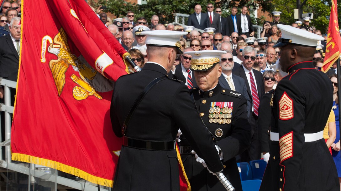 Commandant of the Marine Corps Gen. Robert B. Neller, center, accepts the Marine Corps colors from Gen. Joseph F. Dunford Jr. at Marine Barracks Washington, D.C., Sept. 24, 2015. Neller assumed command from Dunford as the 37th Commandant of the Marine Corps. (U.S. Marine Corps Combat Camera photo by Sgt. Melissa Marnell/Released)