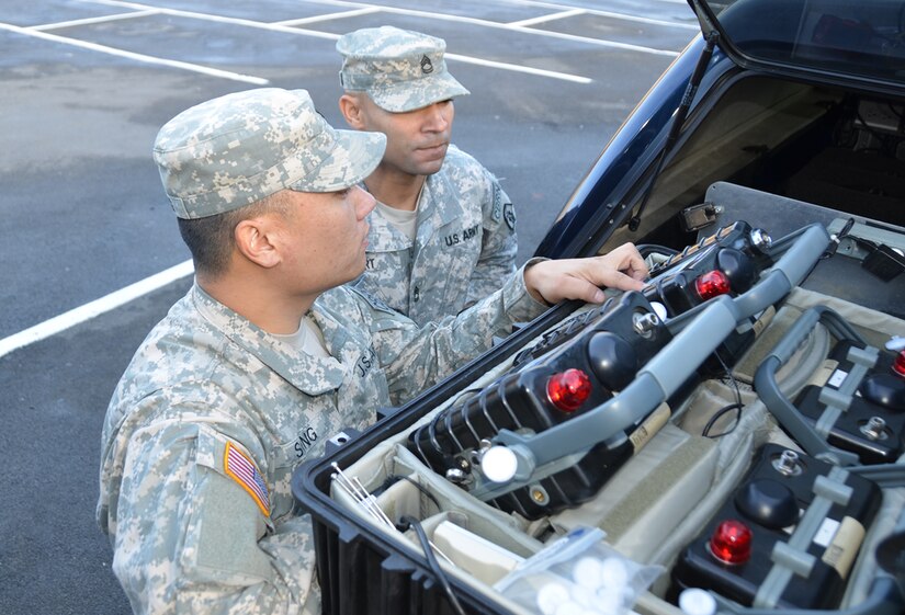 During Warrior Response 15, Spc. Eric Song, 31, of Seattle, Washington, a member for the 773rd Civil Support Team, 7th Civil Support Command, shows a fellow Soldier the equipment his team uses during surveys during chemical, biological, radiological and nuclear events. (Photo by Ignacio Rubalcava, U.S. Army Garrison Rheinland-Pfalz)